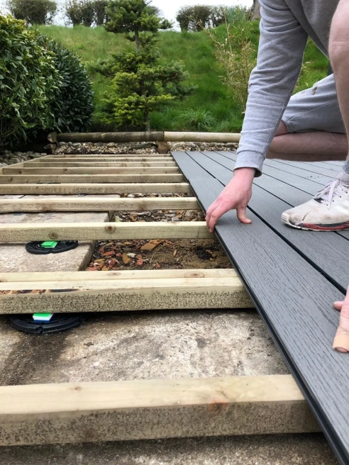 Carpenter laying decking planks